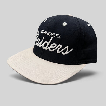 Raree Finds Reebok NFL Vintage Collection LA Raiders snapback hat with black crown, grey brim, and white script logo.