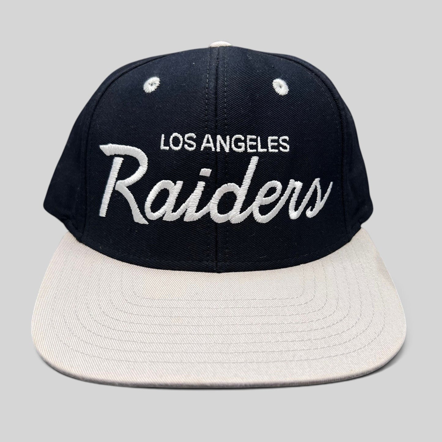 Raree Finds Reebok NFL Vintage Collection LA Raiders snapback hat with black crown, grey brim, and white script logo.