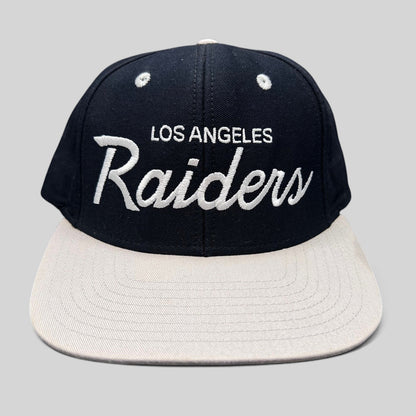 Raree Finds Reebok NFL Vintage Collection LA Raiders snapback hat with black crown, grey brim, and white script logo.