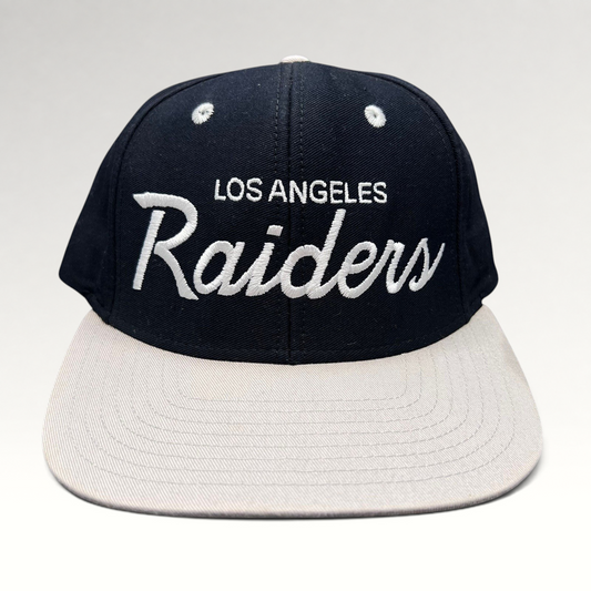 Raree Finds Reebok NFL Vintage Collection LA Raiders snapback hat with black crown, grey brim, and white script logo.