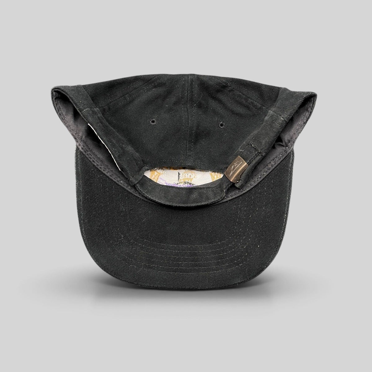 Raree Finds vintage black cotton Los Angeles Lakers 3-Peat championship hat showing the adjustable metal clasp strapback