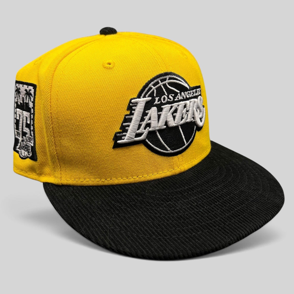 Raree Finds Los Angeles Lakers 9FIFTY snapback hat with a gold crown, black corduroy brim, and 75th anniversary patch.