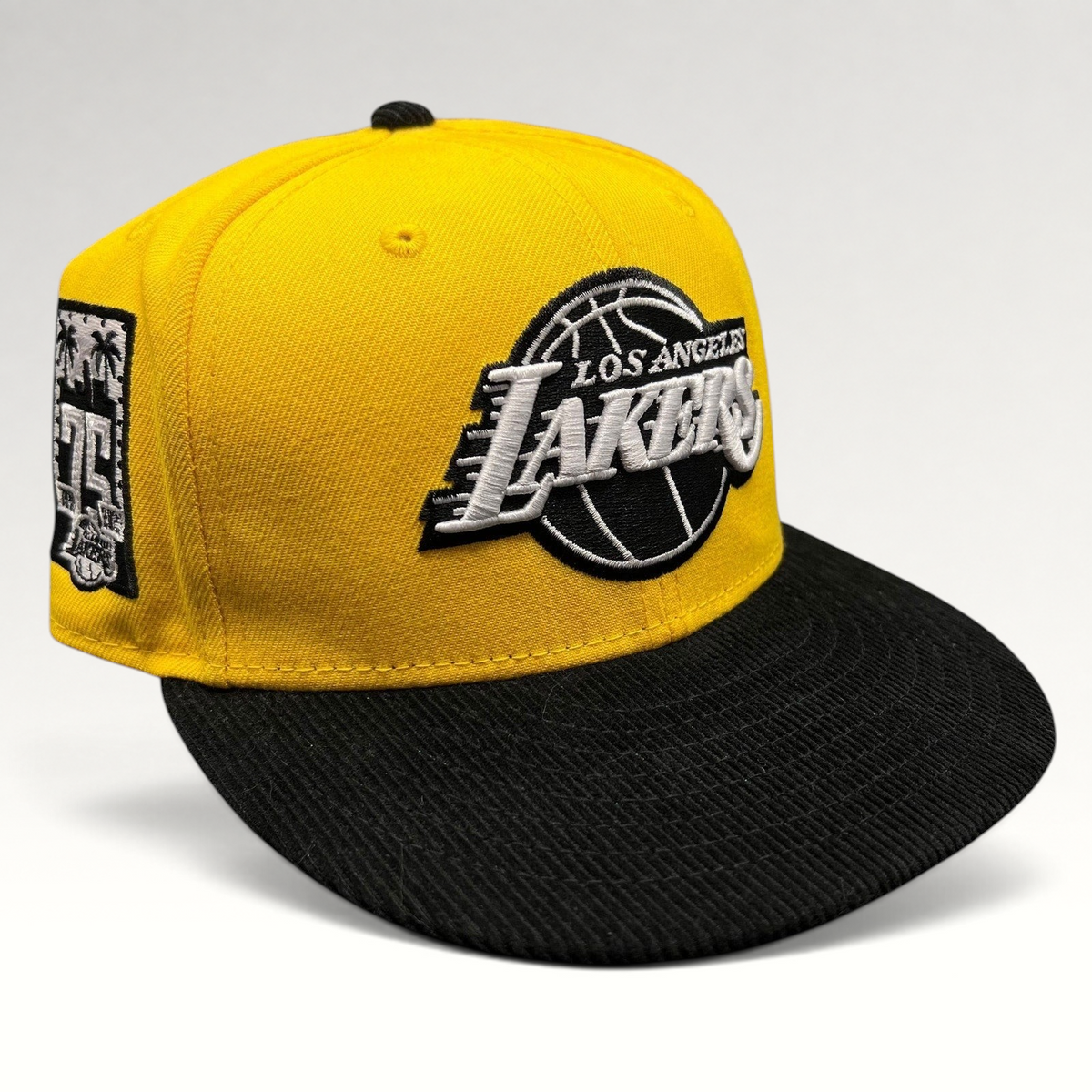 Raree Finds Los Angeles Lakers 9FIFTY snapback hat with a gold crown, black corduroy brim, and 75th anniversary patch.