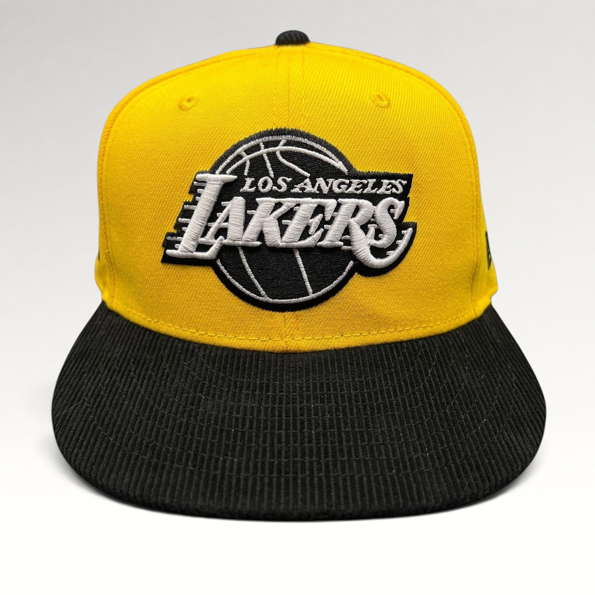 Raree Finds Los Angeles Lakers 9FIFTY snapback hat with a gold crown and black corduroy brim featuring team embroidery.
