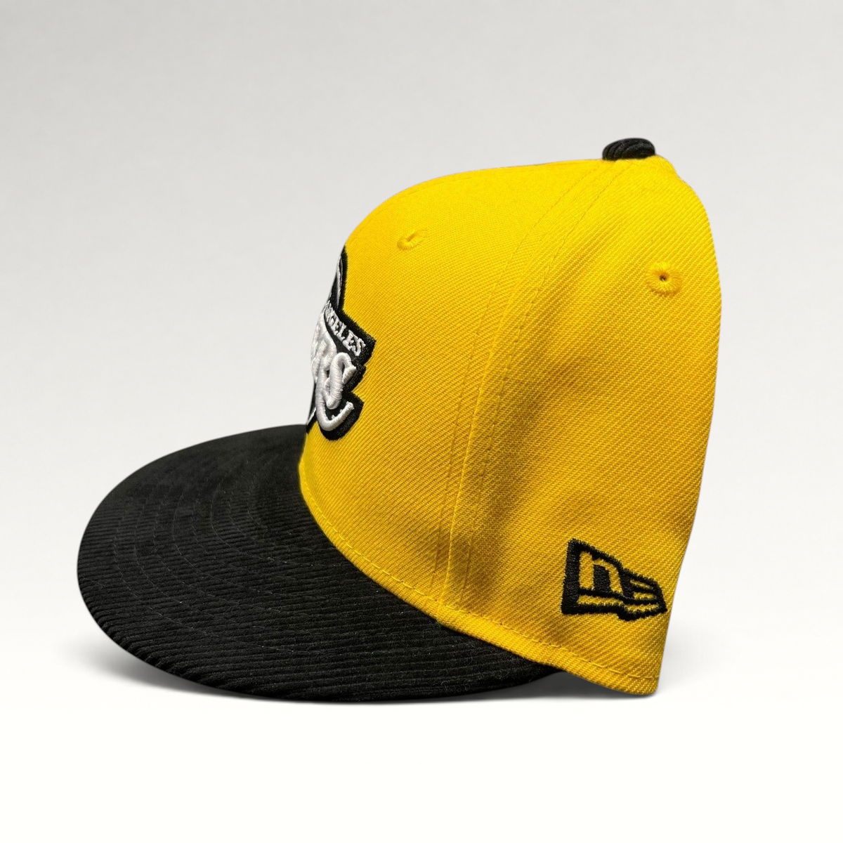 Raree Finds Los Angeles Lakers 9FIFTY snapback hat with a gold crown and black corduroy brim, side profile view.