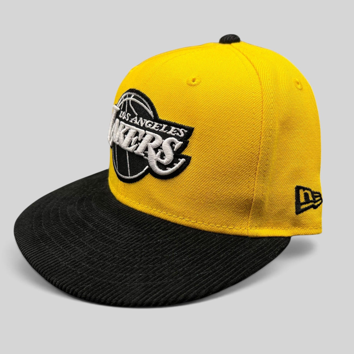 Raree Finds New Era Los Angeles Lakers 9FIFTY snapback hat with a gold crown and black corduroy brim.