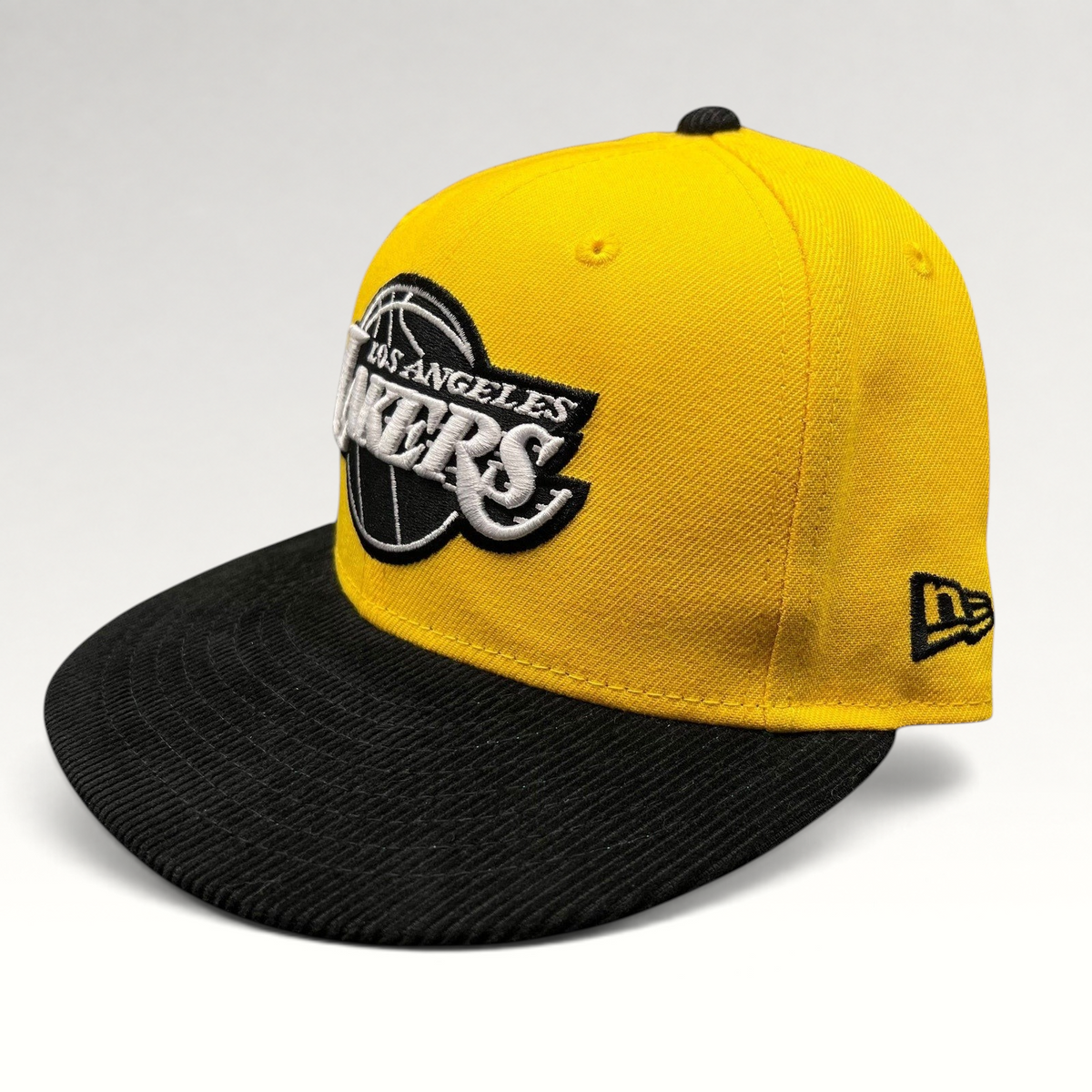 Raree Finds New Era Los Angeles Lakers 9FIFTY snapback hat with a gold crown and black corduroy brim.