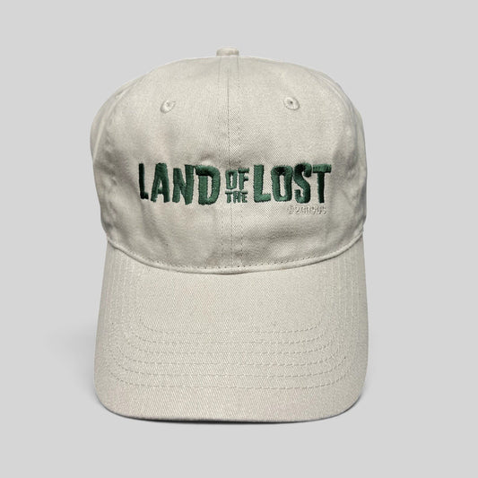 Raree Finds off-white cotton strapback hat with green Land of the Lost movie embroidery and curved brim