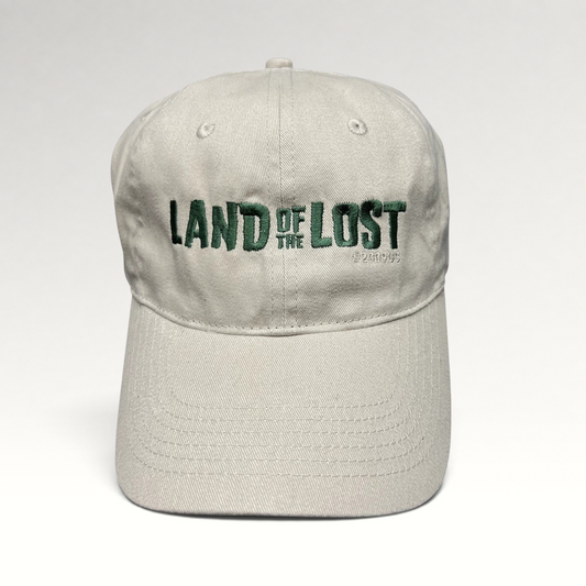 Raree Finds off-white cotton strapback hat with green Land of the Lost movie embroidery and curved brim