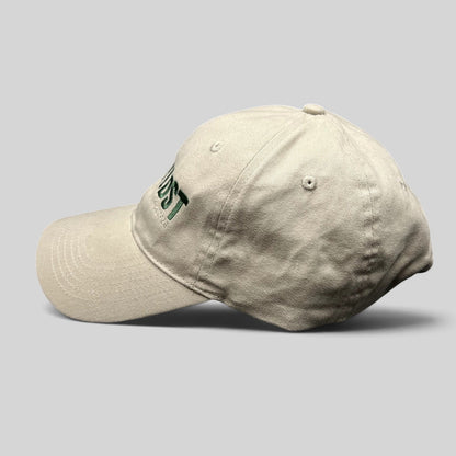 Raree Finds off-white cotton strapback hat with green Land of the Lost movie embroidery and curved brim