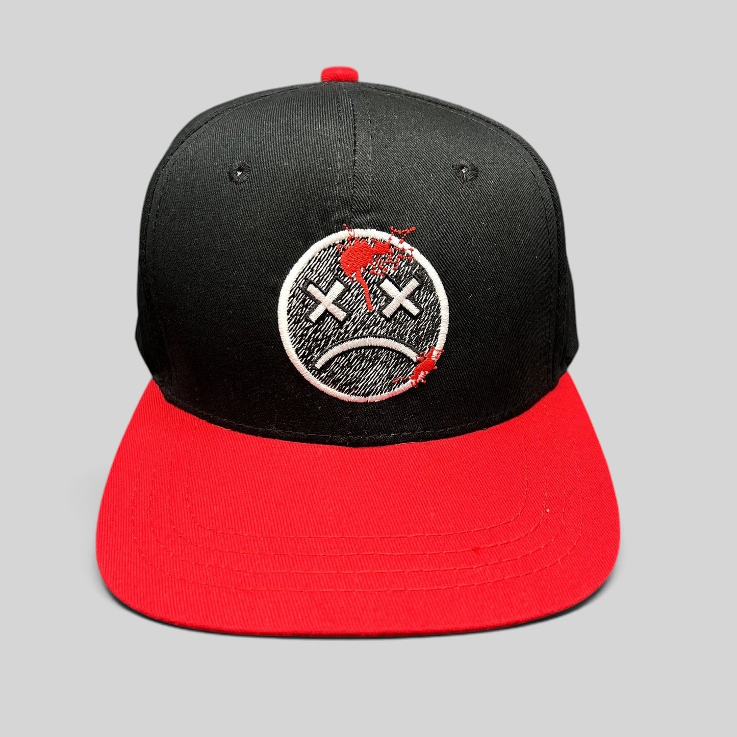 Raree Finds LawBreakers black and red snapback hat with an embroidered distressed smiley face logo on the front