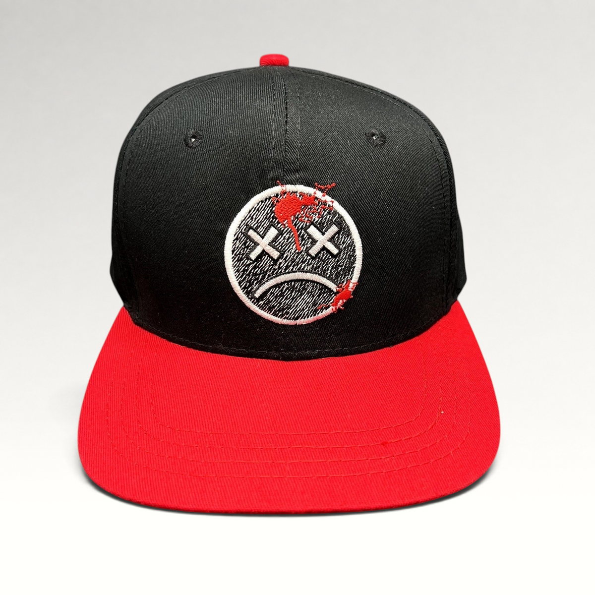 Raree Finds LawBreakers black and red snapback hat with an embroidered distressed smiley face logo on the front