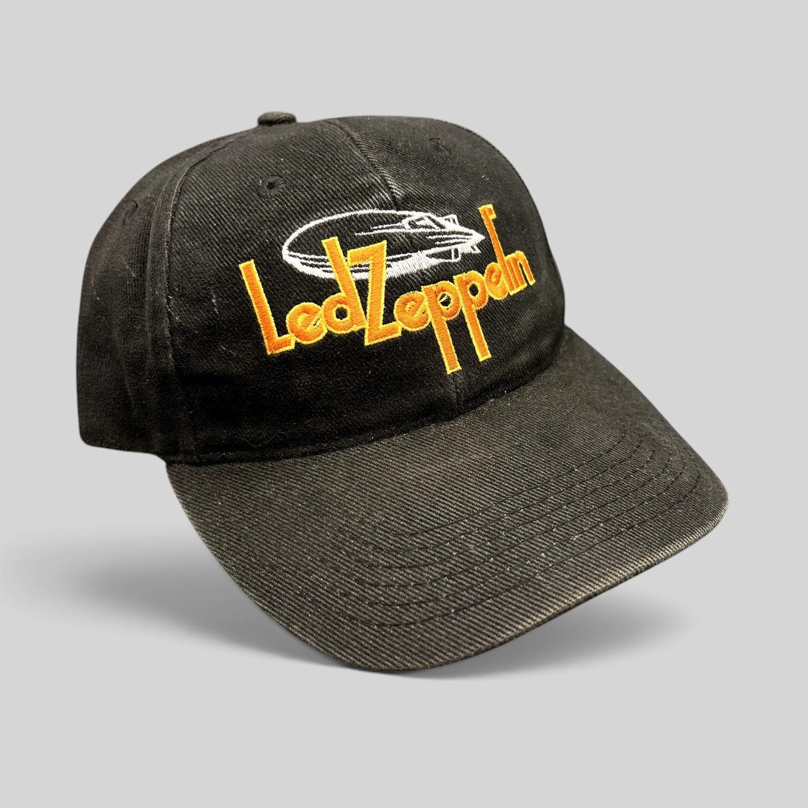 Raree Finds black cotton strapback hat featuring an embroidered orange Led Zeppelin logo and white airship graphic.