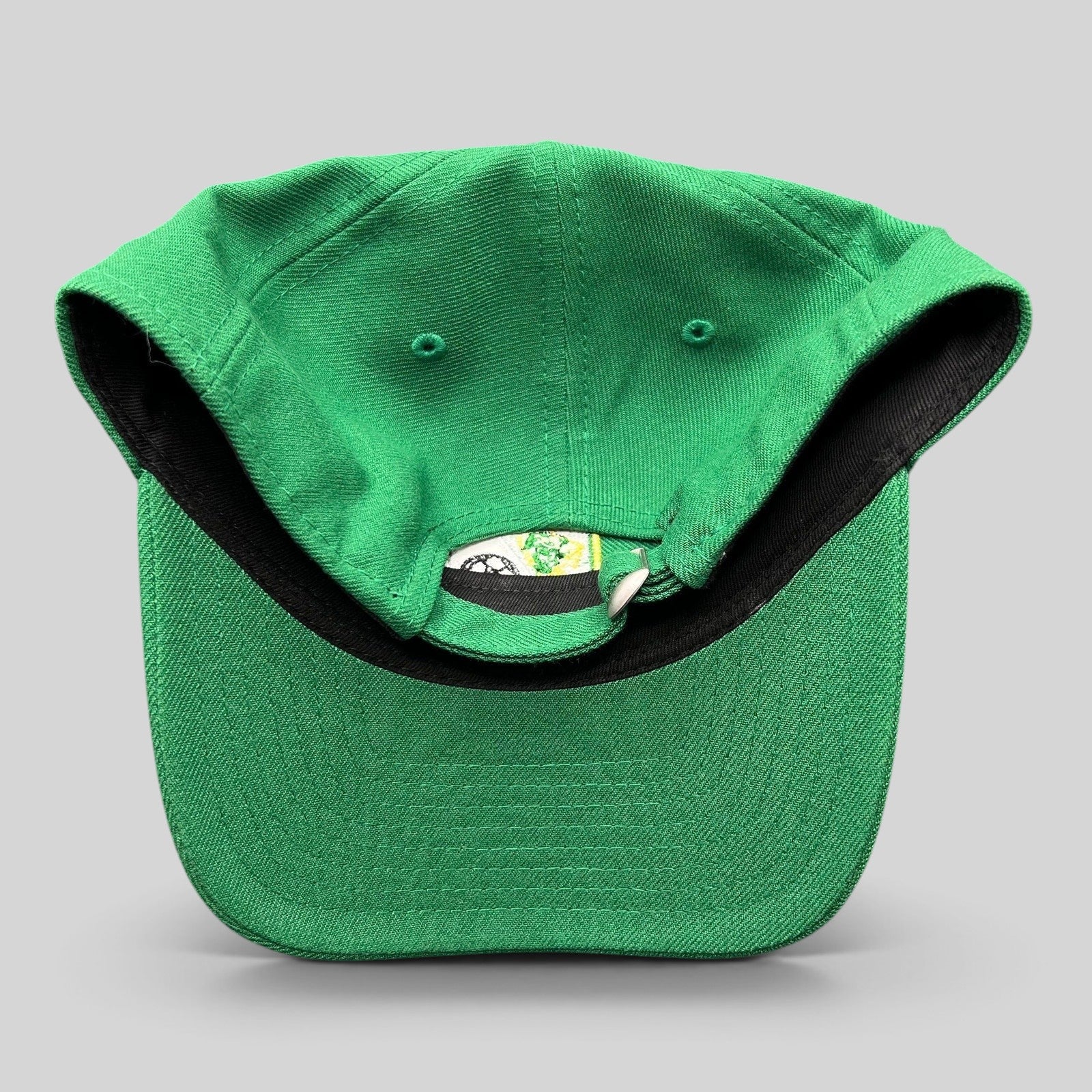 Raree Finds LEON FC green New Era 9TWENTY strapback hat showing the adjustable fabric strap and interior details