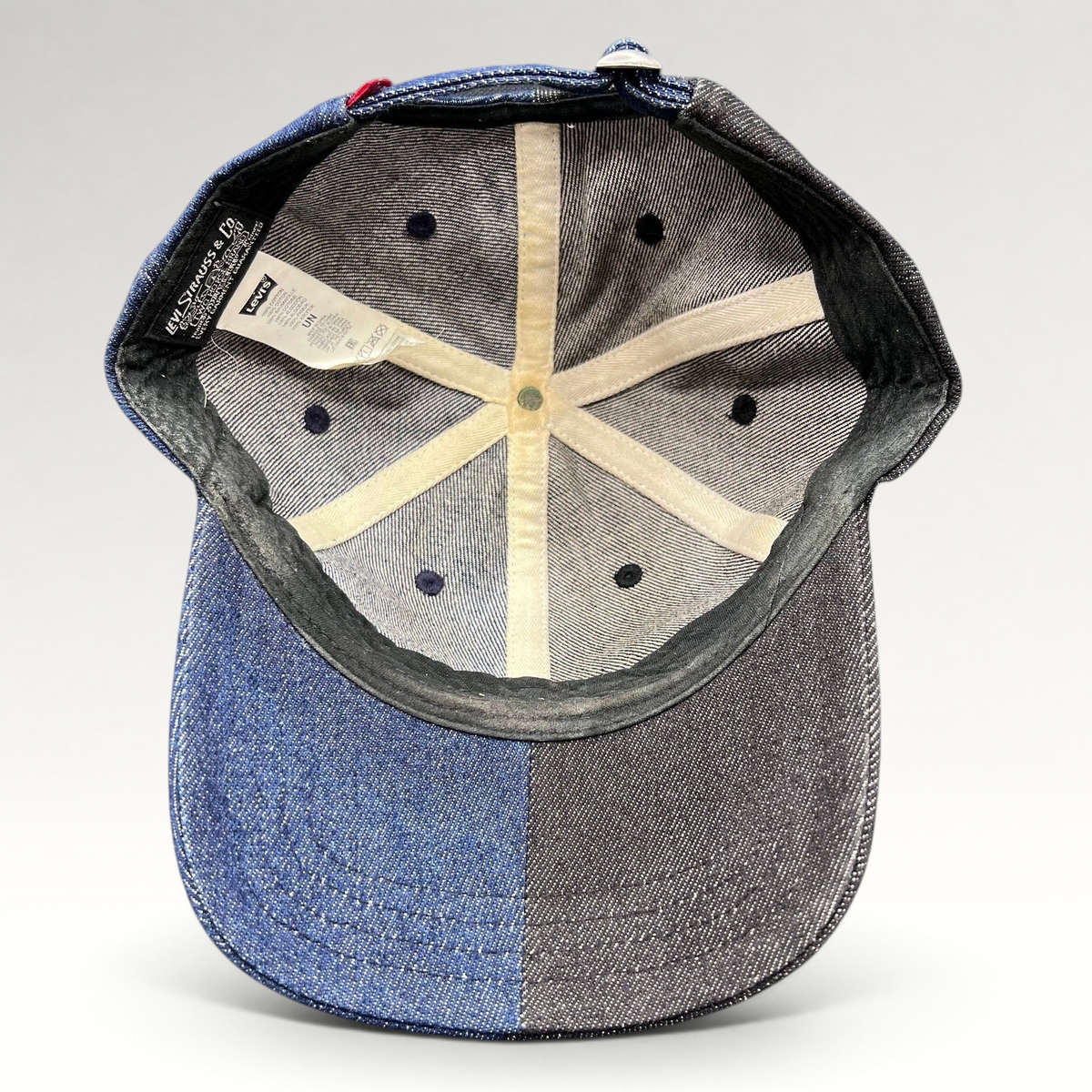 Raree Finds Levi’s two-tone black and indigo denim strapback cap interior showing branded labels and six-panel lining
