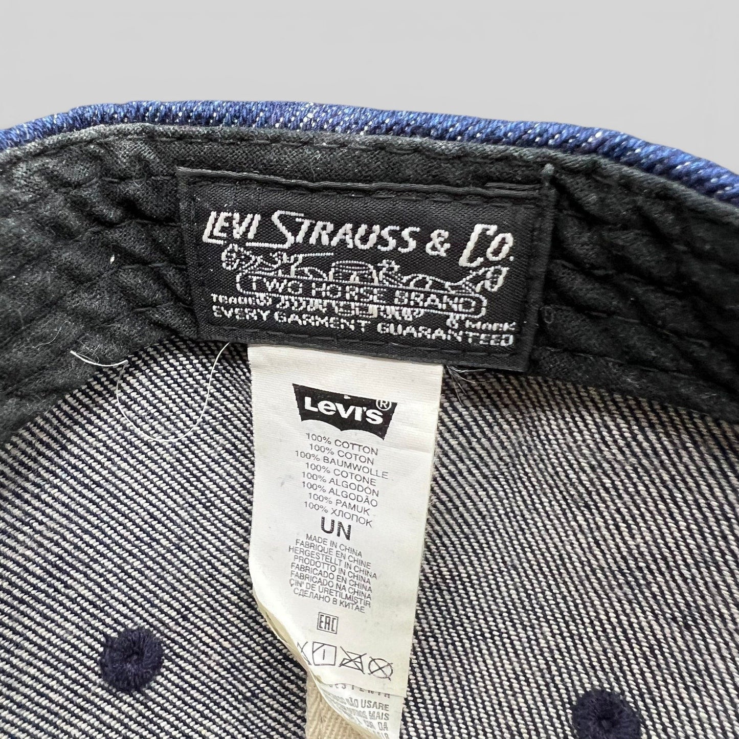Raree Finds Levi Strauss & Co denim cap interior showing woven brand label and 100% cotton care tag