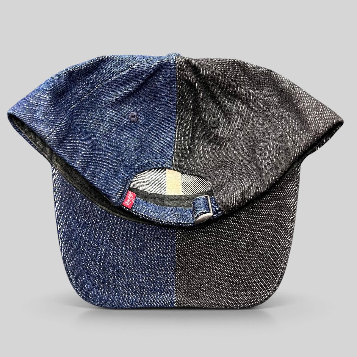 Raree Finds Levi’s two-tone split denim strapback hat in black and indigo cotton with a metal slider closure