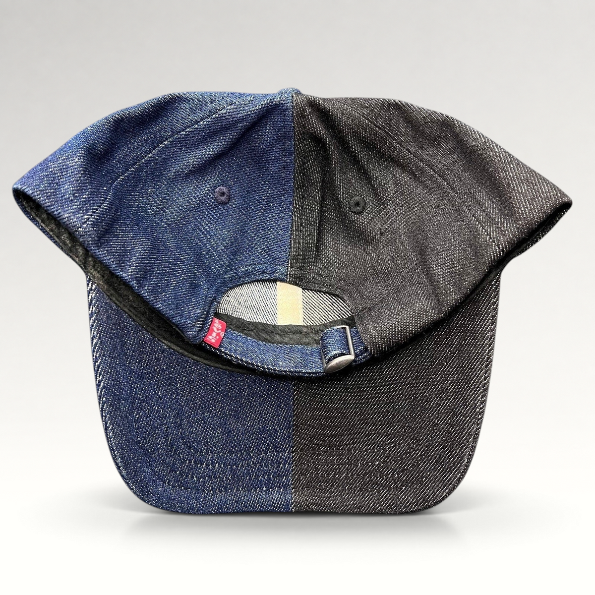 Raree Finds Levi’s two-tone split denim strapback hat in black and indigo cotton with a metal slider closure