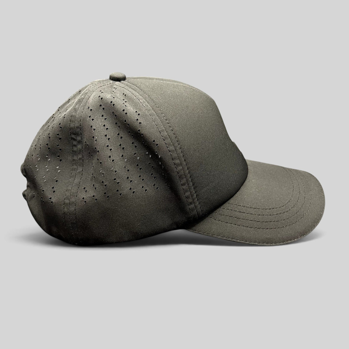 Raree Finds LGCY black performance strapback hat with laser-perforated side panels and a curved brim.