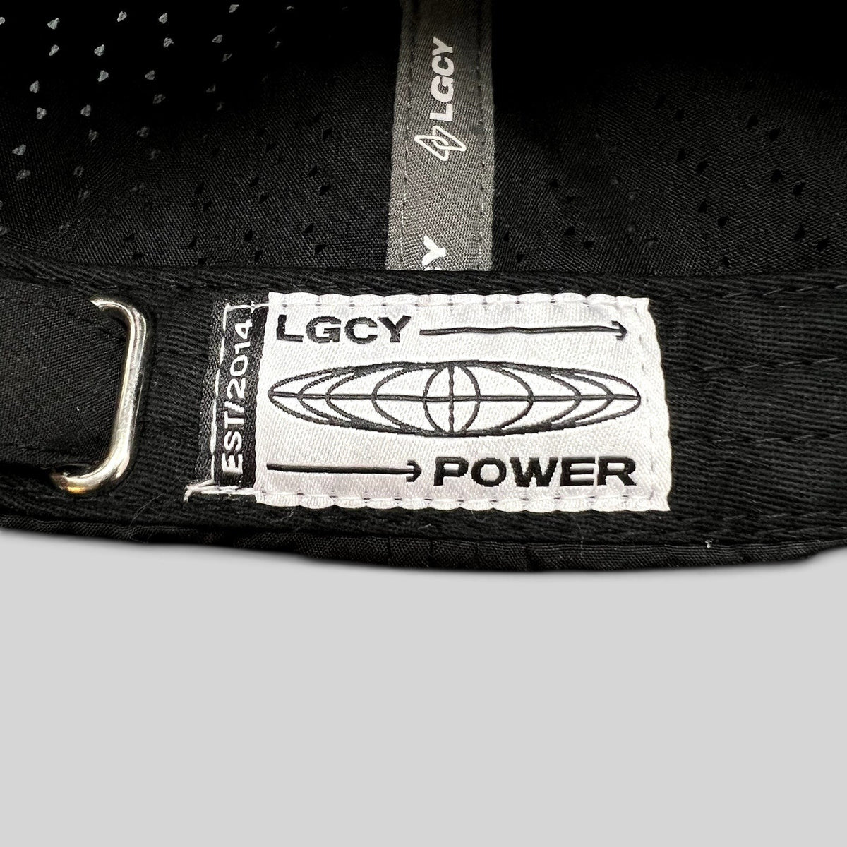 Raree Finds LGCY black performance hat featuring a white woven brand label on the adjustable strapback closure.
