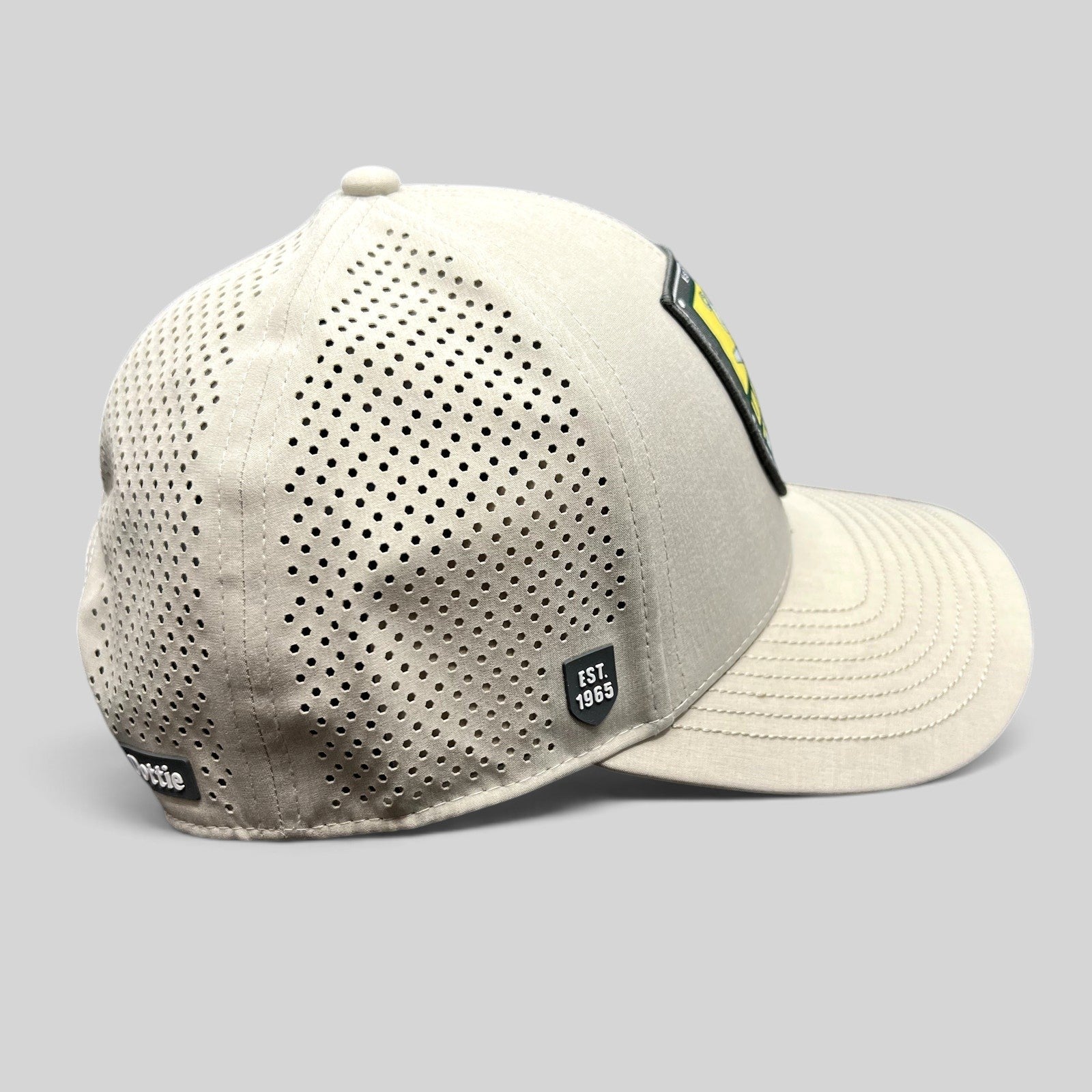 Raree Finds LH Dottie Company tan snapback hat with perforated side panels and Est 1965 shield patch logo