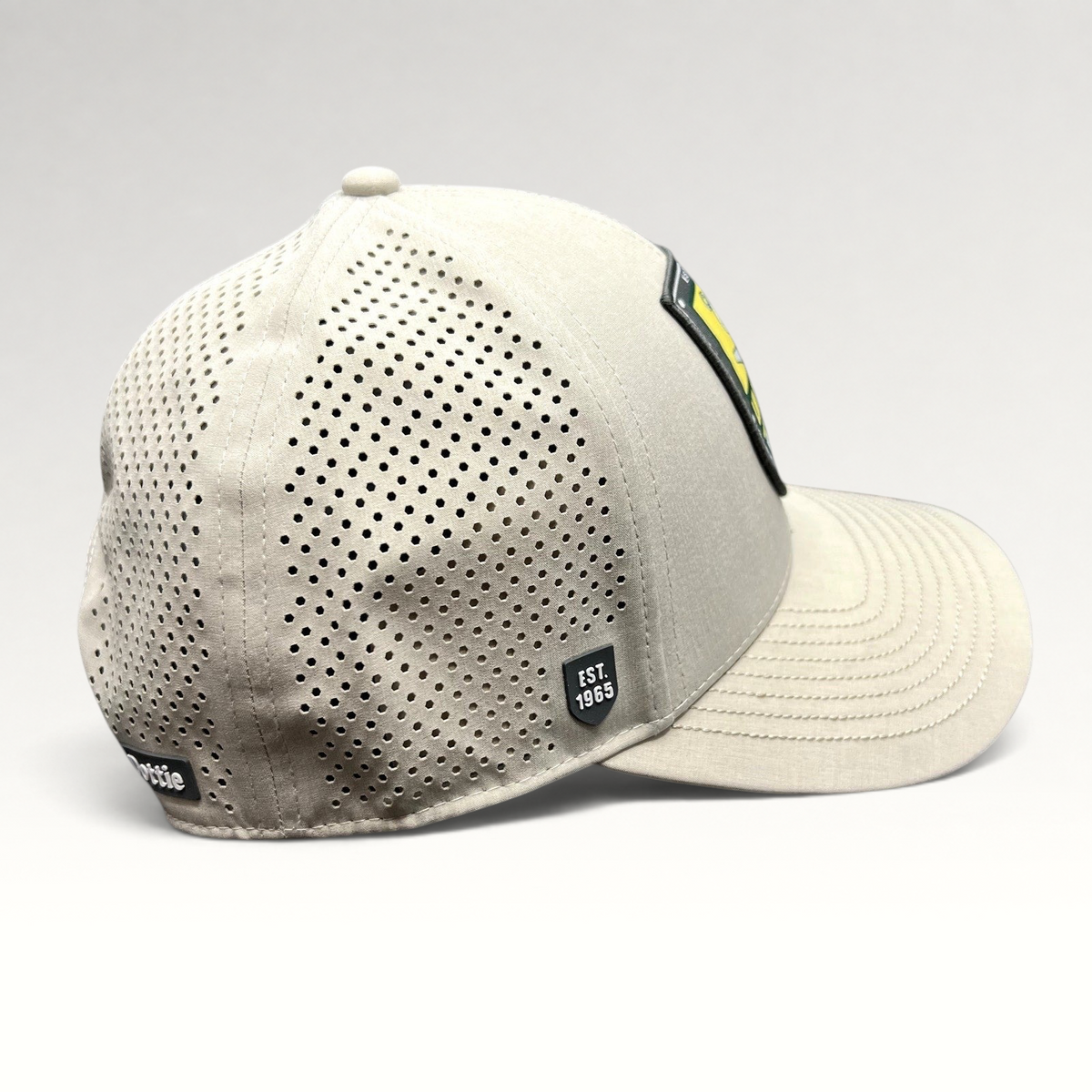 Raree Finds LH Dottie Company tan snapback hat with perforated side panels and Est 1965 shield patch logo