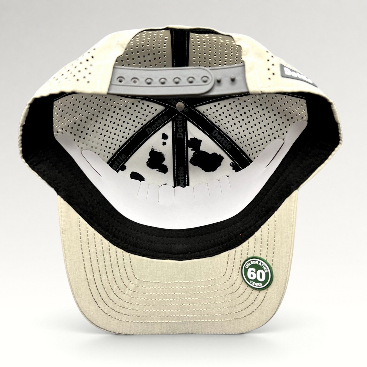 Raree Finds LH Dottie Company tan snapback hat interior view showing perforated panels and branded inner tape