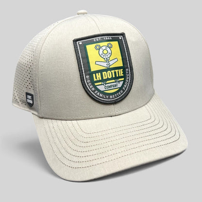Raree Finds LH Dottie Company tan snapback hat with embroidered shield patch and perforated side panels