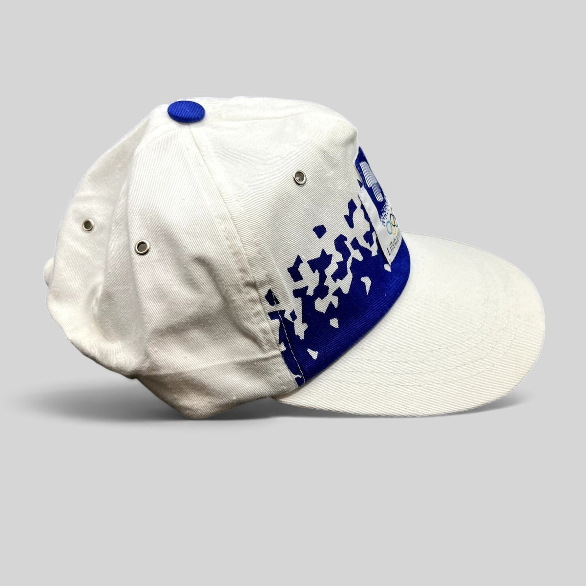 Raree Finds vintage 1994 Lillehammer Winter Olympics hat with white crown, blue brim, and Olympic emblem patch.