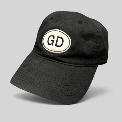 Raree Finds black cotton strapback hat by Liquid Blue featuring a white oval patch with GD logo on the front