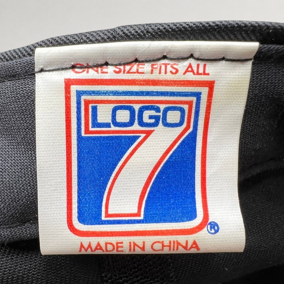 Raree Finds vintage Logo 7 clothing tag with blue and red branding on a white label stitched inside a snapback hat