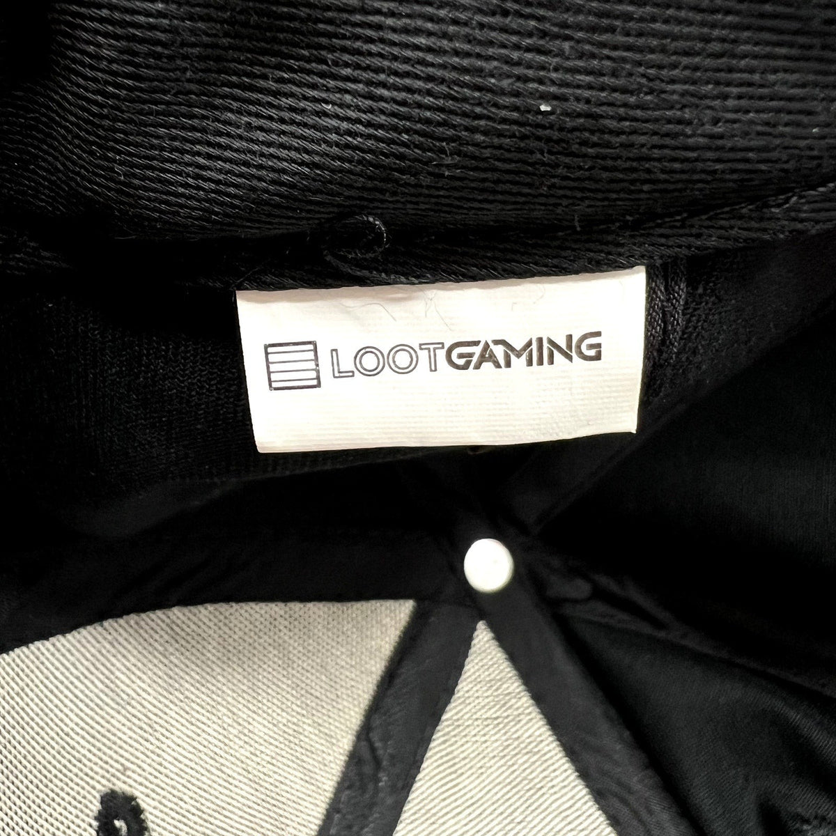 Raree Finds Loot Gaming branded tag inside a black and red LawBreakers snapback hat