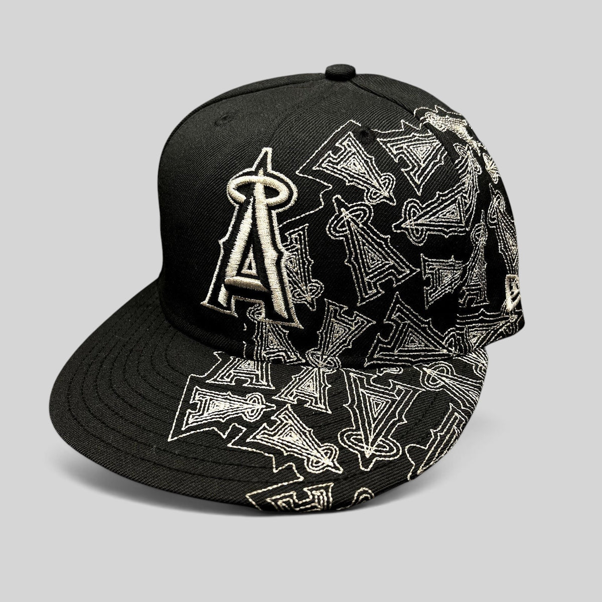 Raree Finds black New Era 59FIFTY Los Angeles Angels fitted hat with silver embroidered logo and all-over side pattern