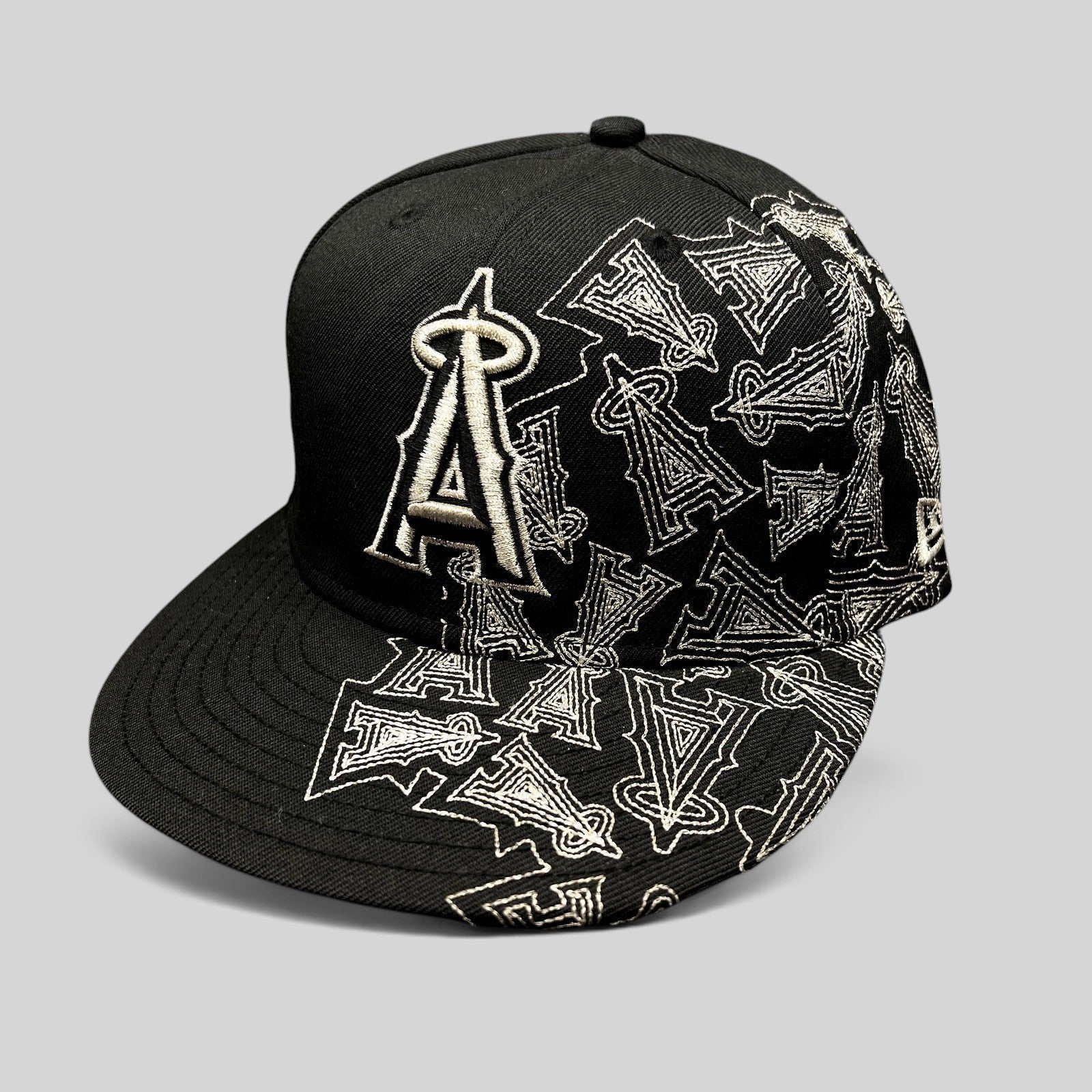 Raree Finds black New Era 59FIFTY Los Angeles Angels fitted hat with silver embroidered logo and all-over side pattern