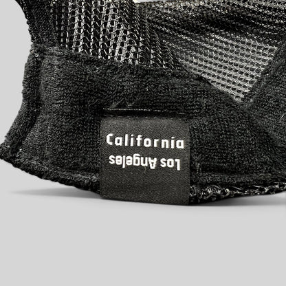 Raree Finds black trucker hat interior tag featuring Los Angeles California text on a mesh back cap