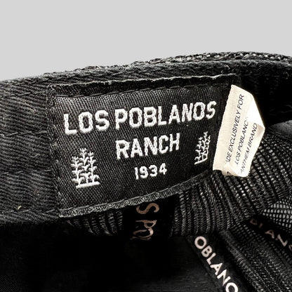 Raree Finds Los Poblanos Ranch 1934 black trucker hat interior label with branding and mesh panel detail