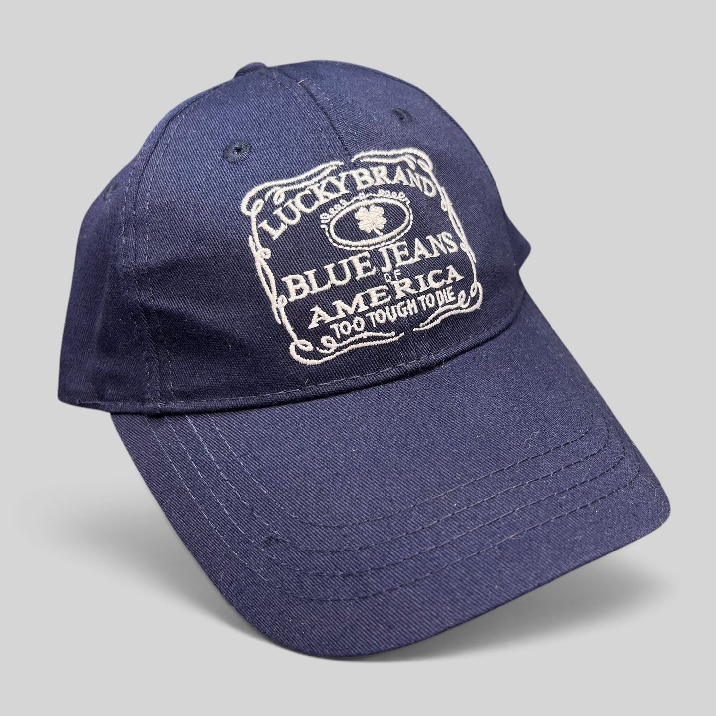 Raree Finds navy cotton twill Lucky Brand snapback hat with white embroidered heritage logo on the front