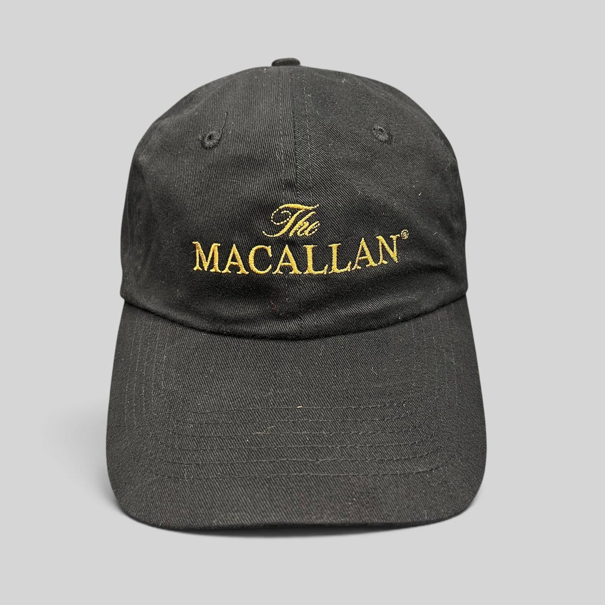 Raree Finds black strapback hat featuring gold embroidered The Macallan logo on the front panel