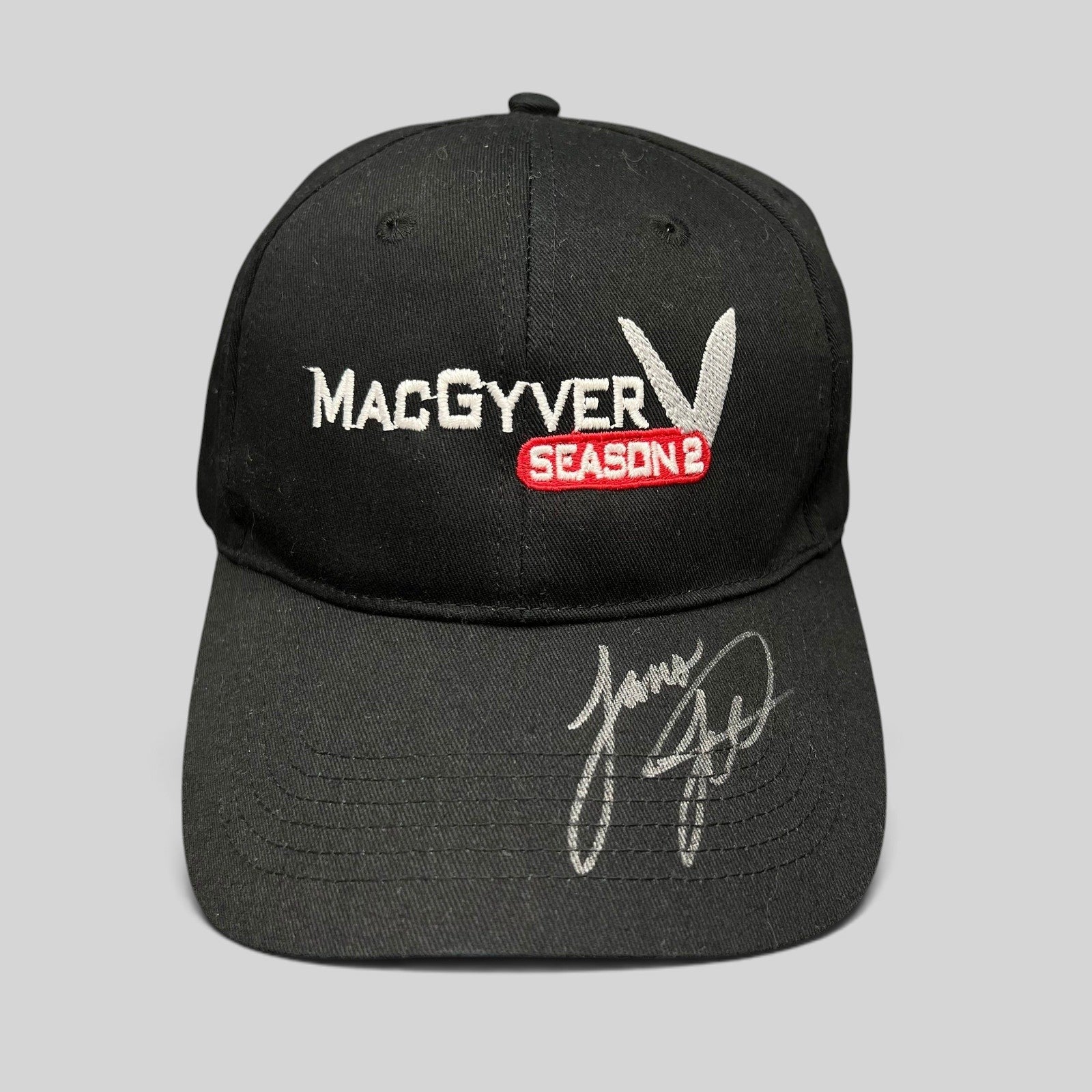 Raree Finds vintage black MacGyver Season 2 promotional strapback hat with embroidered logo and hand-signed brim.