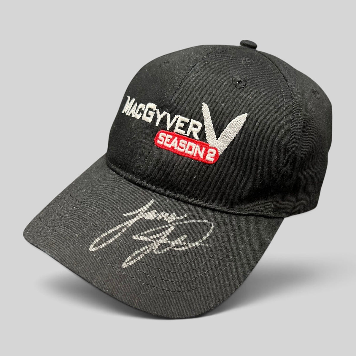 Raree Finds vintage black MacGyver Season 2 promotional strapback hat with embroidered logo and hand-signed brim.