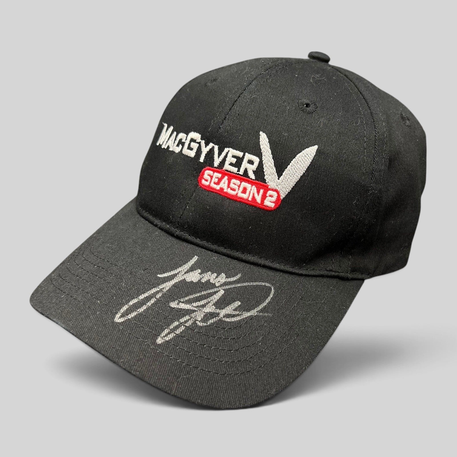 Raree Finds vintage black MacGyver Season 2 promotional strapback hat with embroidered logo and hand-signed brim.