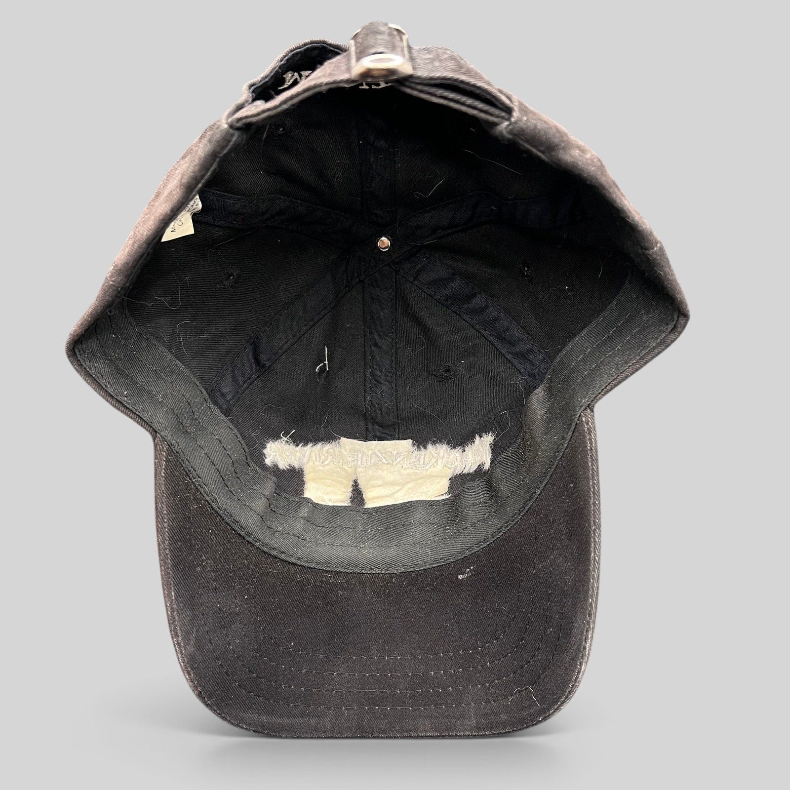 Raree Finds vintage dark brown Mackenzie River Pizza Co strapback hat showing the interior crown and adjustable strap