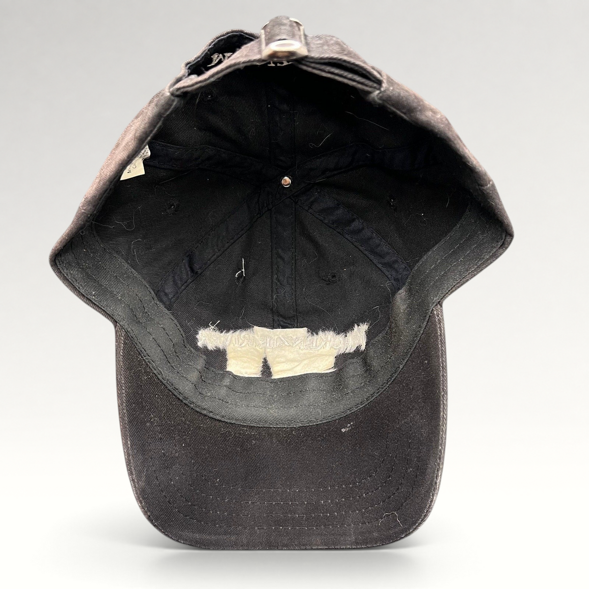 Raree Finds vintage dark brown Mackenzie River Pizza Co strapback hat showing the interior crown and adjustable strap