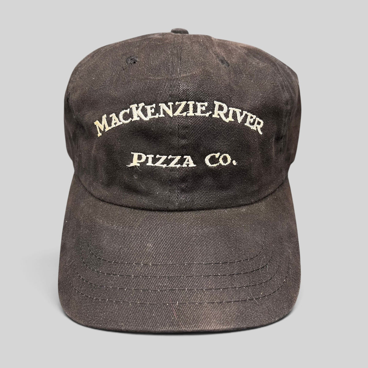 Raree Finds vintage dark brown Mackenzie River Pizza Co. strapback hat with white embroidered arched lettering