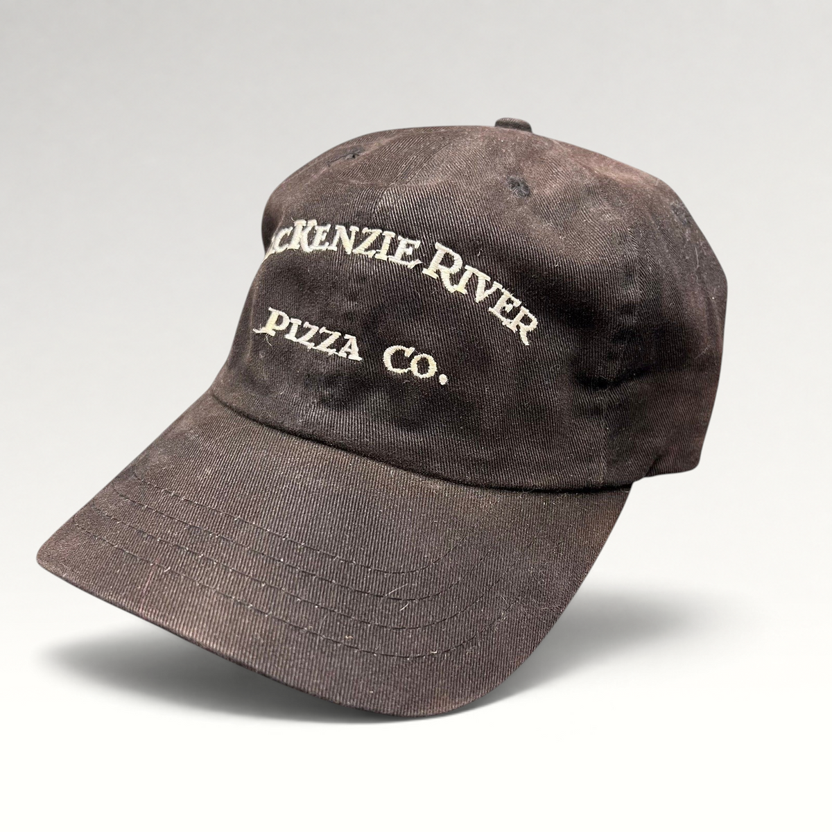 Raree Finds vintage dark brown Mackenzie River Pizza Co. strapback hat with white embroidered lettering.