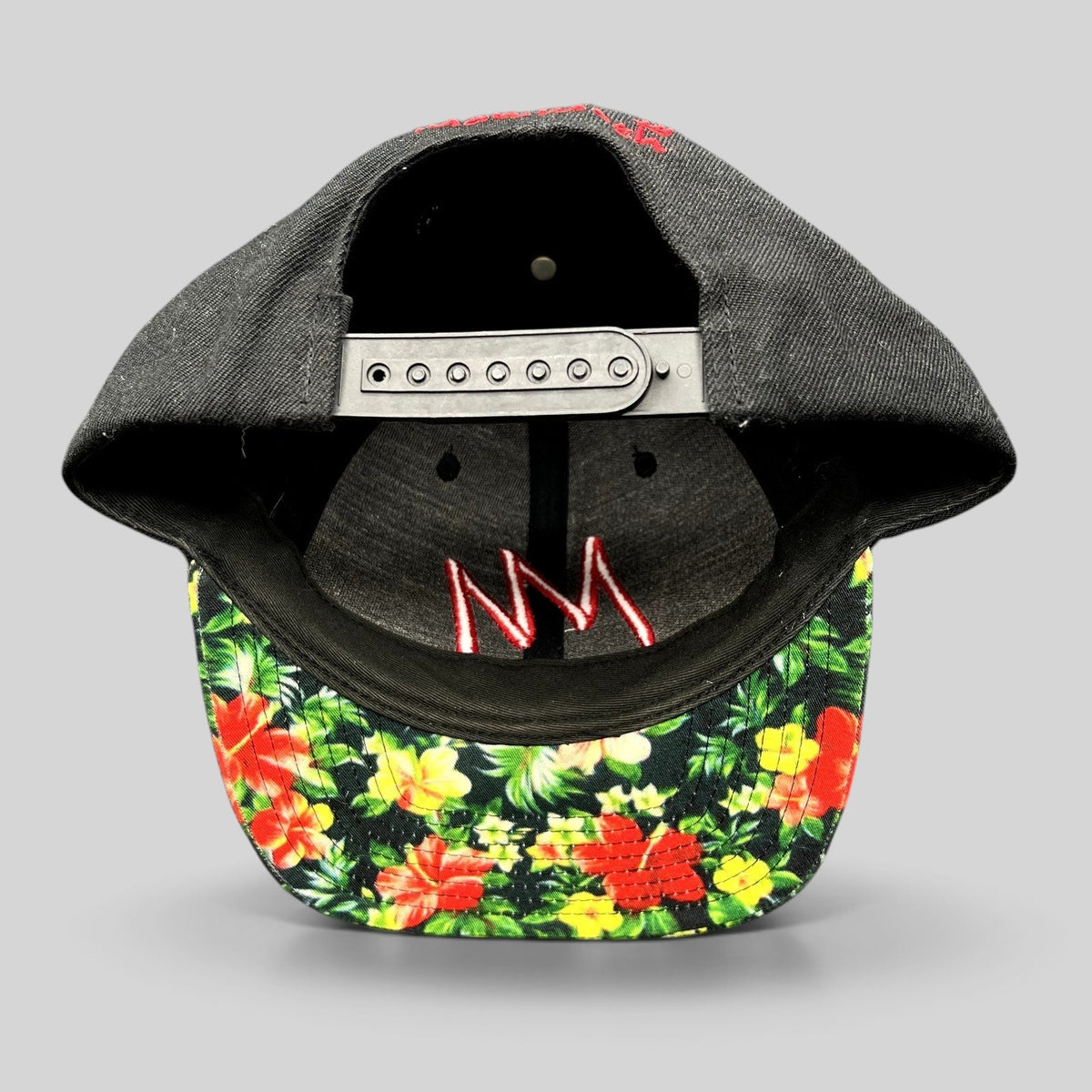 Raree Finds Mammoth Mountain snapback hat with black crown, tropical floral print brim, and red embroidered logo.