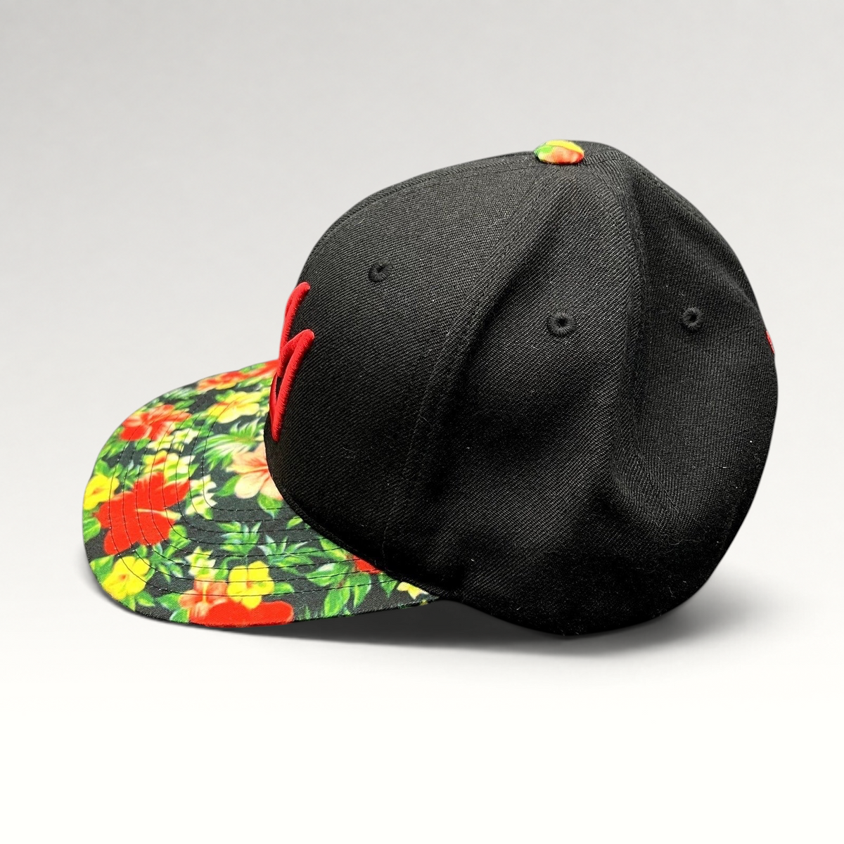 Raree Finds Mammoth Mountain black snapback hat with a vibrant tropical floral print flat brim and red logo