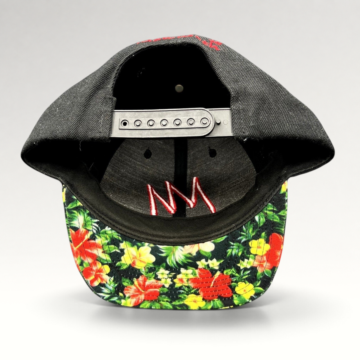 Raree Finds Mammoth Mountain snapback hat featuring a black crown, tropical floral print brim, and adjustable strap.