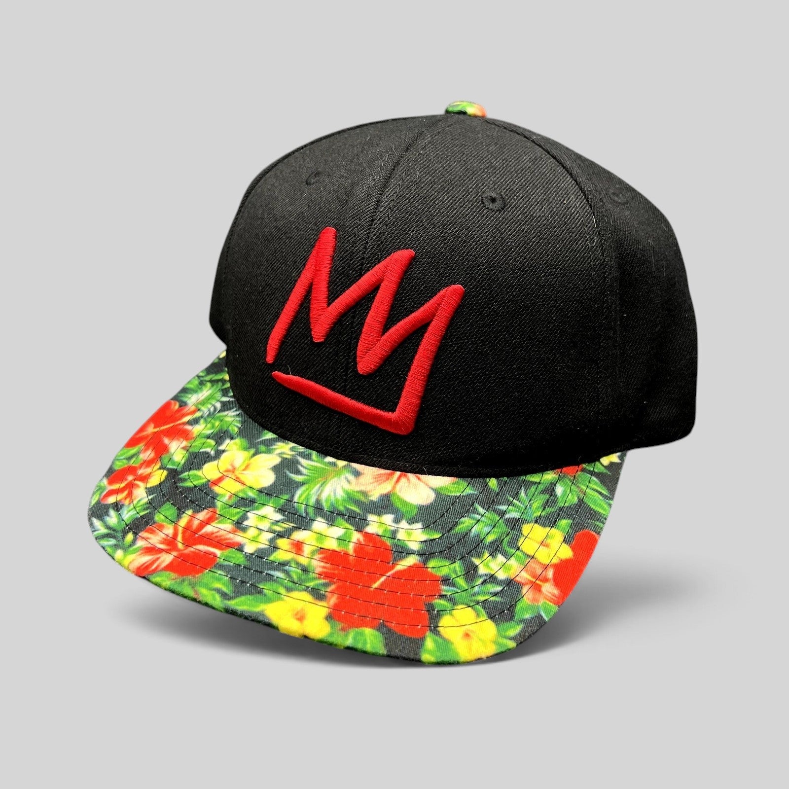 Raree Finds Mammoth Mountain snapback hat with a black crown, red embroidered logo, and tropical floral flat brim.