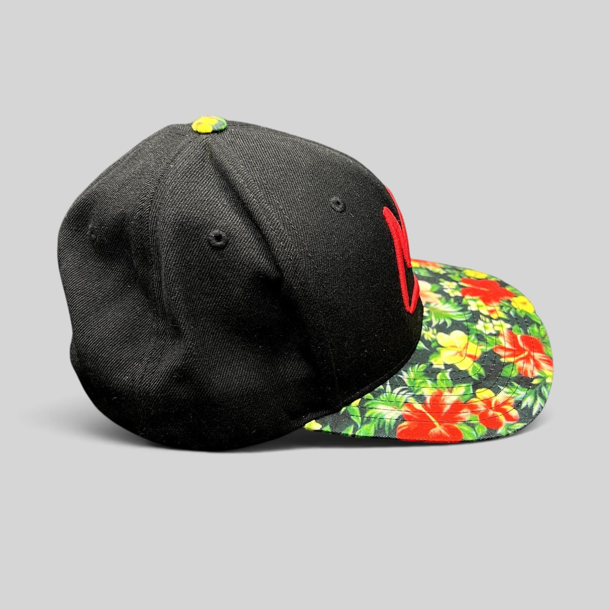 Raree Finds black Mammoth Mountain snapback hat with a vibrant tropical floral print flat brim and red logo.